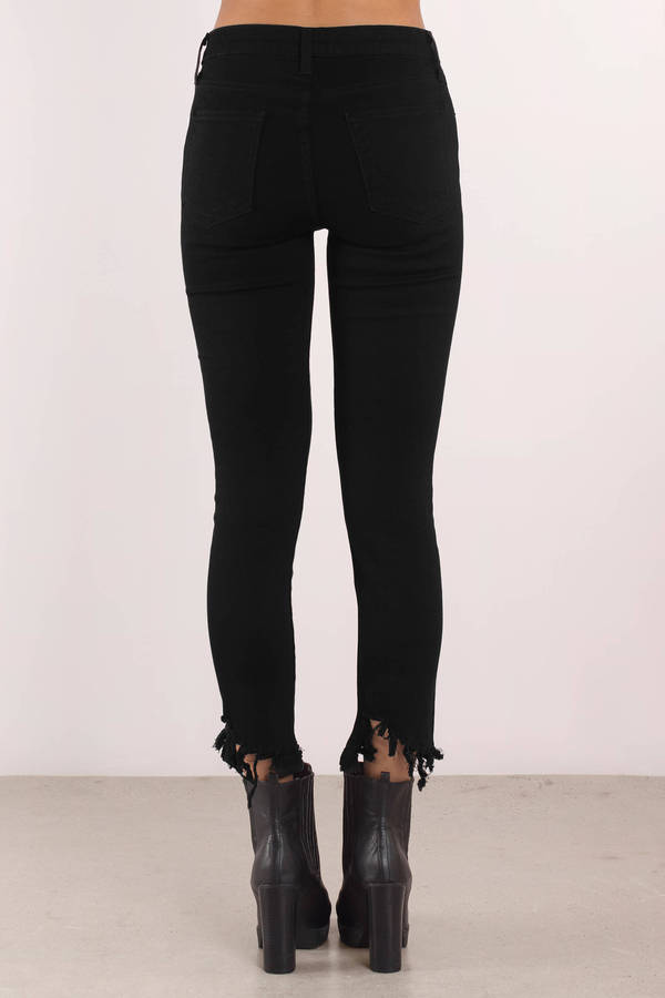 black jeans with frayed bottoms